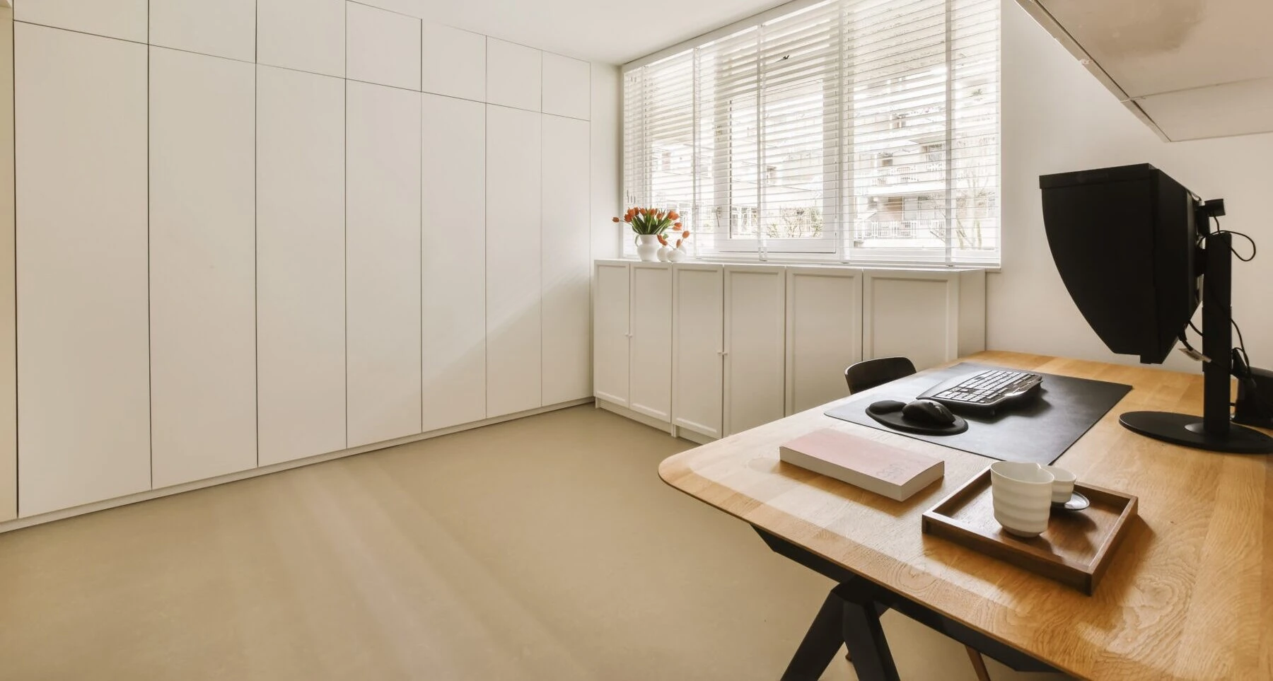a white room with a desk and a window 2023 11 27